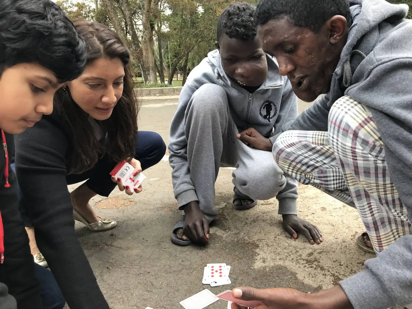 A card game on the ground with friends
