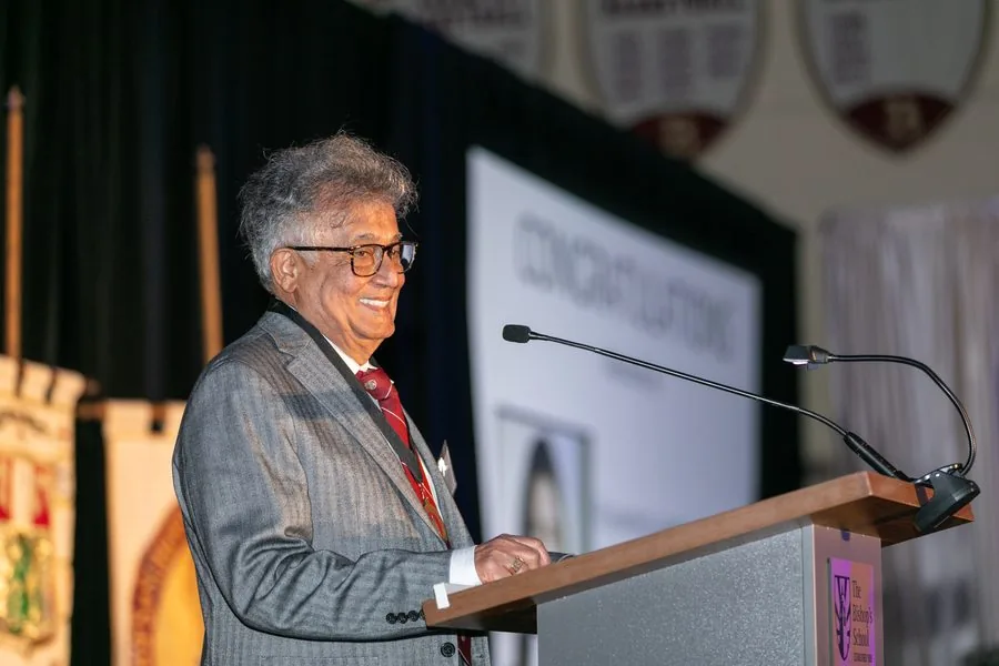 Aliya's father accepting the Rosamond Larmour Loomis Service Award at The Bishop's School